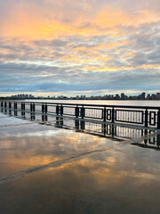 Sunset on the embankment after the rain. Reflection of the sky in the wet pavement, Kazan, Russia
