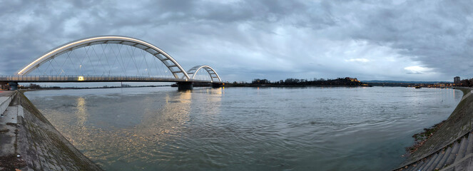 panoramic view of the bridge over Danube river in Novi sad, reflected in the water surface  - obrazy, fototapety, plakaty