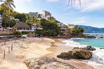 Aerial view of a tropical resort beach with palm trees and turquoise water in Puerto Vallarta
