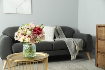 Beautiful bouquet of fresh flowers on coffee table in room, space for text