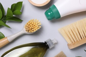 Flat lay composition with different cleaning supplies on light gray background