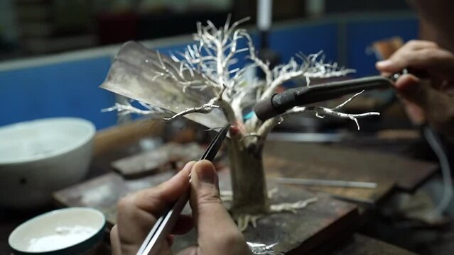 Silversmith fusing close up melting.