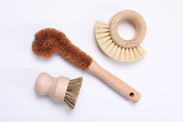 Cleaning brushes on white background, flat lay