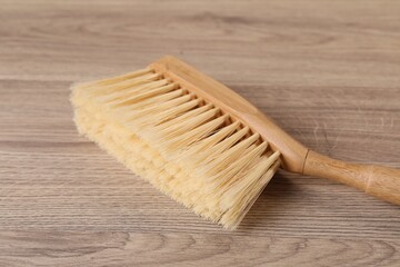 One cleaning brush on wooden table, closeup