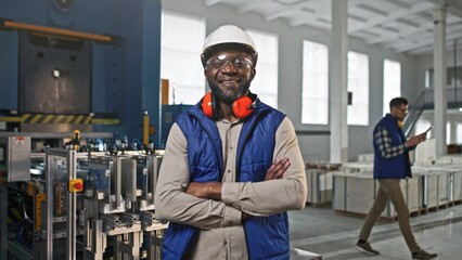 Close-up portrait of professional joyful positive smiling African-American male worker. Man posing...
