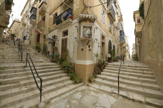 Corner with stairs and picture of the Virgin Mary on a street in Senglea, Malta, Mediterranean