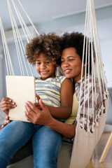Happy african american single mother helping child with distance education. Online education - 780621493