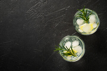 Gin tonic, traditional cocktail on black background. Top view with space for design. - 780621807