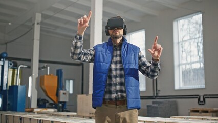 Tall big middle-aged caucasian male trying artificial intelligence virtual reality VR equipment. Curious involved man in blue vest zooming scrolling swiping right up and down.