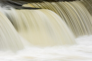 Landscape captured with blurred motion of a cascade on the Rabbit River, Michigan, USA