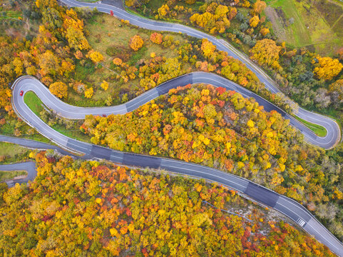 A car driving along the mountain road on an autumn day, Tuscan-Emilian Apennine National Park, Tuscany, Italy