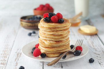 Pancakes with berries in rustic style