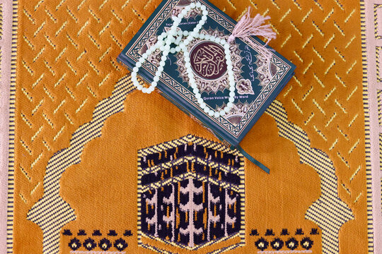 Quran and Muslim prayer beads on Islamic prayer mat with the Kaaba, Symbol of Islam, Chau Doc, Vietnam, Indochina, Southeast Asia