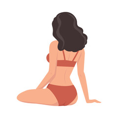 A woman in a swimsuit sits with her back to the viewer and looks into the distance. The wind ruffles her hair. View from the back.
