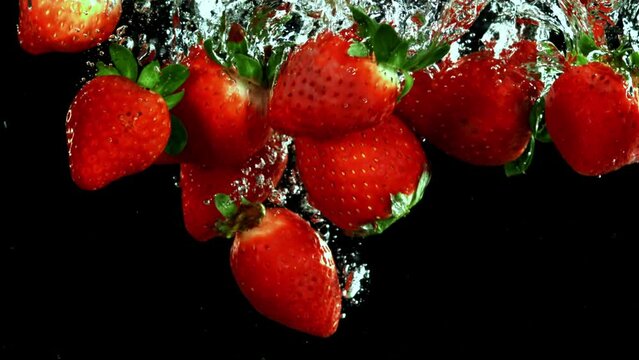 Super slow motion strawberries underwater. High quality FullHD footage