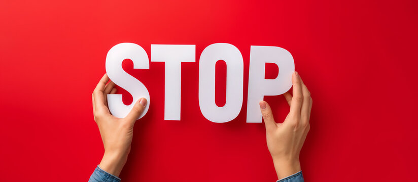 female hands holding cut paper letters forming word stop on red background, generative ai