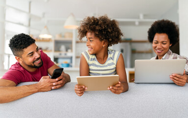 Obsessed to tech devices happy african american family using digital tablet, computer, smartphones - 780627229