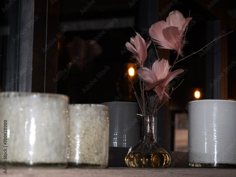 Canvas Prints vases filled with flowers sit in front of candles on a counter