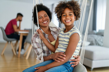 Family concept. Happy african american mother and daughter spendig fun time together at home - 780629672