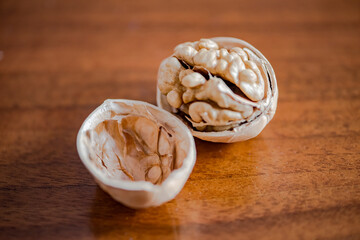 Walnuts that have been smashed open for consumption, with walnut skins on the table