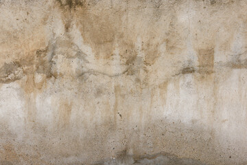 Old water damaged grey plaster wall surface with yellow smudges. Full-frame flat background and...