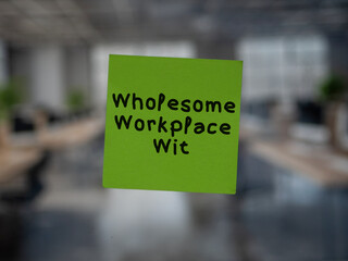Post note on glass with 'Wholesome Workplace Wit'.