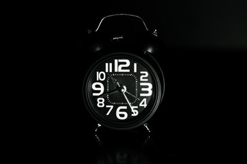 Close up of Black retro alarm clock on dark background