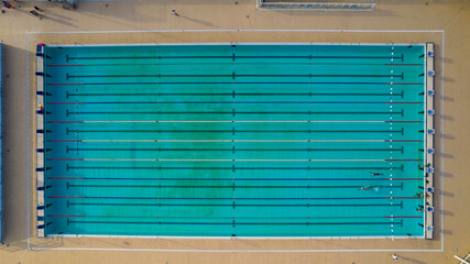 Olympic pool with two swimmers training and competing in Salvador, Bahia