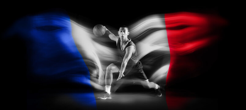 Monochrome image of man, basketball player during game in motion with ball on black background with flag of France element. Concept of professional sport, competition, tournament. Banner. Sport event