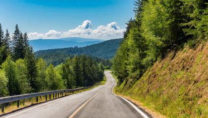 Fototapeta premium slope country asphalt road uphill through the forest and hills with trees beside