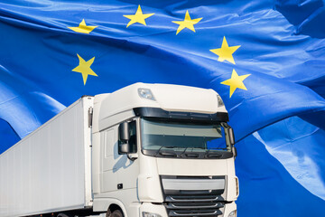 White transport truck in front of a waving European flag - 780657069