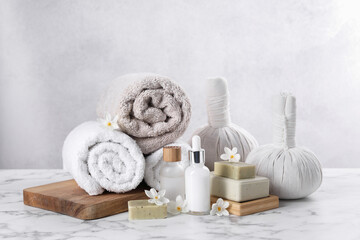 Composition with spa supplies and flowers on white marble table