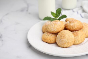 Tasty sweet sugar cookies on white marble table, closeup. Space for text