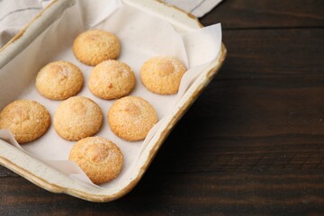 Tasty sweet sugar cookies in baking dish on wooden table, closeup. Space for text