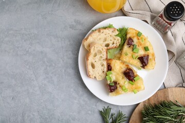 Tasty sausage casserole served on grey table, flat lay. Space for text