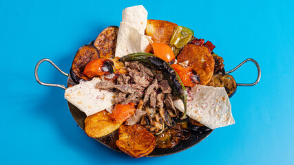 Sadj dish - Azerbaijani cuisine. Roasted beef and vegetables in metallic pan