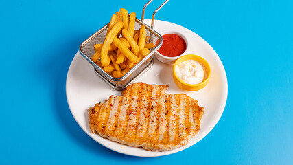 Chicken steak and fries basket on plate