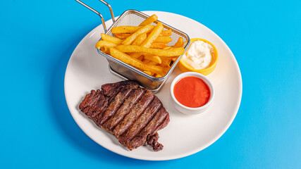 Beef steak and fries basket on plate