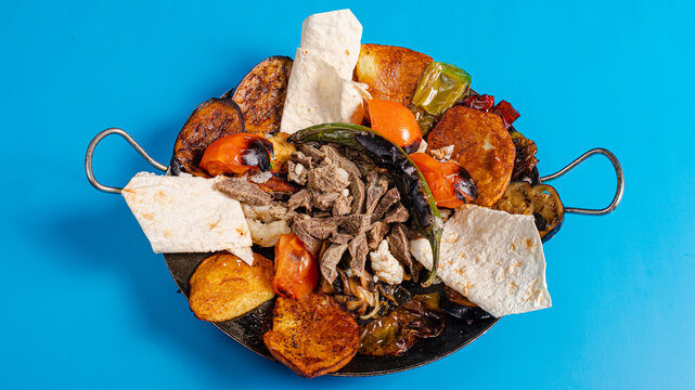 Sadj dish - Azerbaijani cuisine. Roasted beef and vegetables in metallic pan