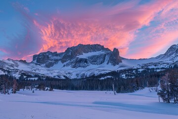 Breathtaking landscape of the Rocky Mountains at sunrise, Crimson and gold twilight skies embrace snowy mountain backdrop, with frosted trees in the foreground lending a serene winter stillness.