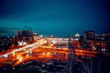  Urban Lights : A bustling urban landscape at dusk, where the fading daylight merges with the...