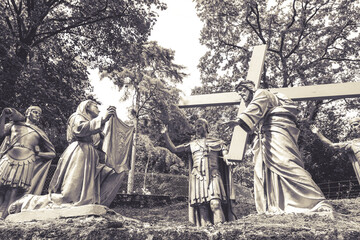 The Way of the Cross - The sanctuary of Our Lady of Lourdes - France 
Statues of Simon of Jesus Christ carrying his cross, Saint Veronica , and the roman soldiers around them.