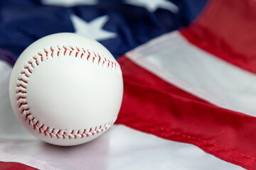 close up of white baseball on the stars and stripes flag of the United States of America