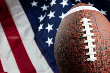 american football ball right side with United stated flag in background