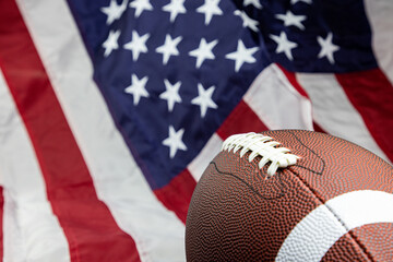 brown leather football on isolated on american flag
