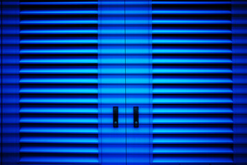 Dark blue closed metallic doors urban street background - 780680210