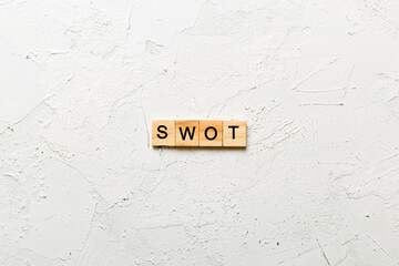 swot word written on wood block. strength weakness opportunity threats text on table, concept