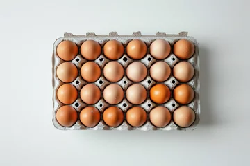  Fresh eggs in a carton packaging on a clean white background with space for text or design concept © SHOTPRIME STUDIO