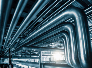 Network of gleaming steel pipes runs with precision, illustrating vital veins of industrial...