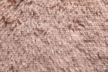Texture of pink faux fur as background, closeup